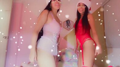 Cute Asian girl unwraps christmas present while teacher watches