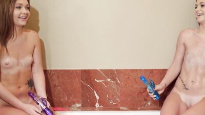 Two skinny white chicks masturbate in the bathtub before sharing a BBC