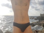 Klaus Joe naked next to a restless sea