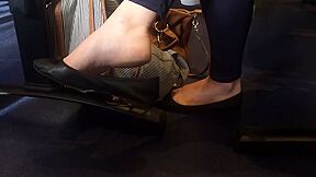 Classy Business Lady Dangling Her Black Ballerina Shoes In Public