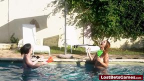 A strip down game outdoors in the swimming pool