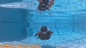 Carissa in the leopard catsuit swimming in the pool with bound ankles
