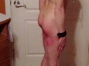 Slave performing jumping jacks with a belly full of water after enema
