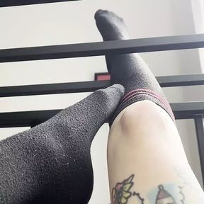 Caged Slave Girl in knee High Socks Rubs Feet Against Bars