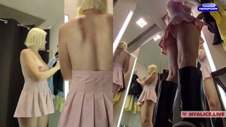 Upskirt view on Blonde with big boobs tries on transparent clothes. Video from public locker room