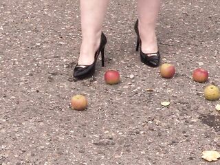 Crush fetish outdoors Plump legs in high heel shoes crush apples