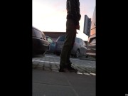 A quick piss stop behind a car