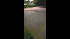 Teenage naked in lighted parking lot in city
