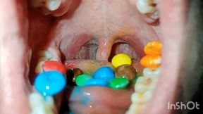 Chewing mini M&Ms With my teeth and my uvula in the background!