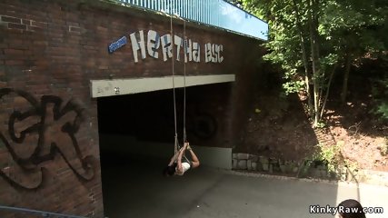 Hottie suspended from a bridge in public