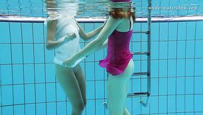 Two lovely dolls swimming naked in a huge pool giving awesome underwater show