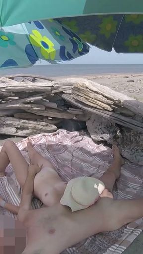 On a nudist beach in Tenerife, the stepdaughter jerks off her stepfather's cock without shame   Clip 2