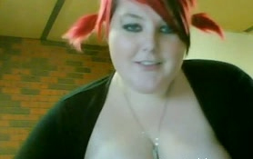 Lewd BBW with dyed hair shows her tits and meaty cunt on camera