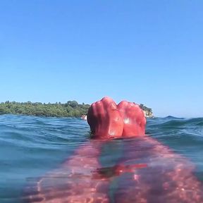 red stocking in the sea at the public beach