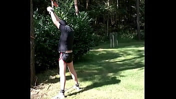 Me tied to a tree in leather shorts and tanga