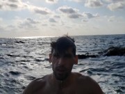 Klaus Joe naked next to a restless sea