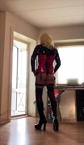 Blonde fetish CD in boots and red and black PVC and latex