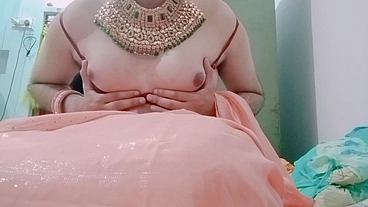 Indian trans woman Gaurisissy pressing her big boobs and fingering in her clean shaved big ass in red saree