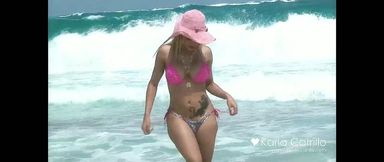 Karla Carrillo in the pink hat on the beach