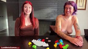 Horny lesbians play a strip game using sexy toys.