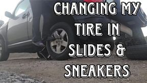 Changing my tire in flats and sneakers