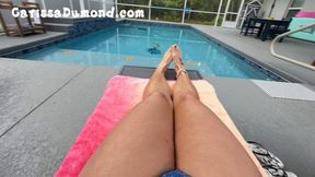 Carissa poolside rubbing oil on her legs, bikini line and feet