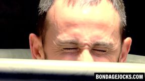 Submissive gay man played with a toy in rough BDSM