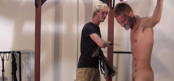 Naked hanging sub Dean takes a harsh and painful flogging while muffling his screams