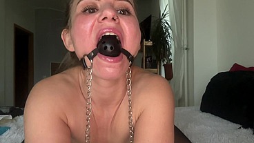 Masturbating with clamps on nipples and a ball gag in the mouth