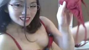 Nerdy charming Asian babe with red lips goes solo and fucks with toy