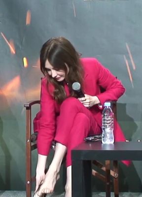 Woman sitting on chair with microphone