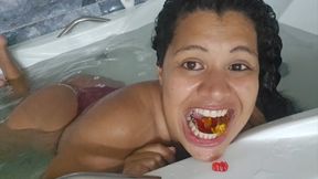 Giantess devouring gummy bears in the bathtub