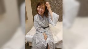 Older Japanese woman seductively undressing in traditional robe