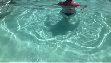 Italian MILF shows off her big natural tits in a wet bikini at the pool