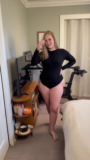Curvy black woman struts in a bodysuit