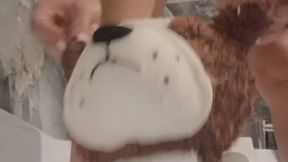 My big plush dog is peeing directly in his mouth.