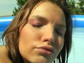 Lesbians have fun with a dildo at pool party