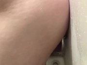 Riding dildo on wall of shower