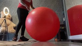 girl in sneakers jump on big re yoga ball