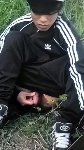 Cute Asian gay twink in a black-and-white adidas tracksuit and Campus sneakers masturbates and cums outdoors   Clip 1