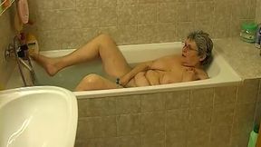 Busty old whore pleases herself in the shower room