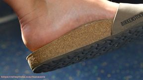 Birkenstock slippers and beauty feet on train, feet and soles close-up. Ignoring foot fetish