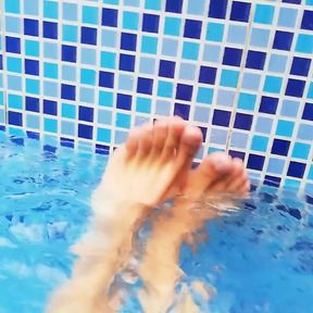 Feet in the pool with water