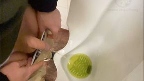 Amateur guy caught pissing in a public toilet's urinal - he then quickly plays with his cock before leaving
