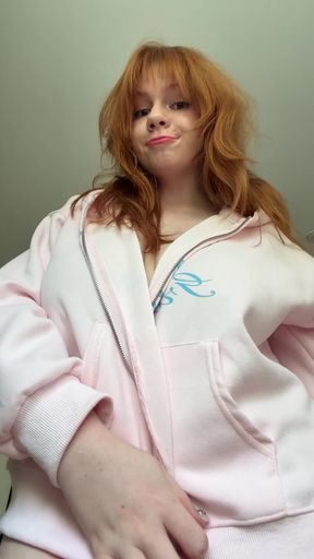 Red-haired woman in pink hoodie