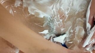 Alice inside the toilet lathers her vagina with foam then shaves leaving a strip of hair on her pubis