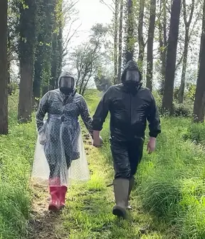 Plastic raincoat and gasmask in the woods