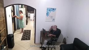 while the husband works, the wife in a towel greets the delivery man.