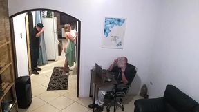 while the husband works, the wife in a towel greets the delivery man.