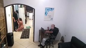 while the husband works, the wife in a towel greets the delivery man.